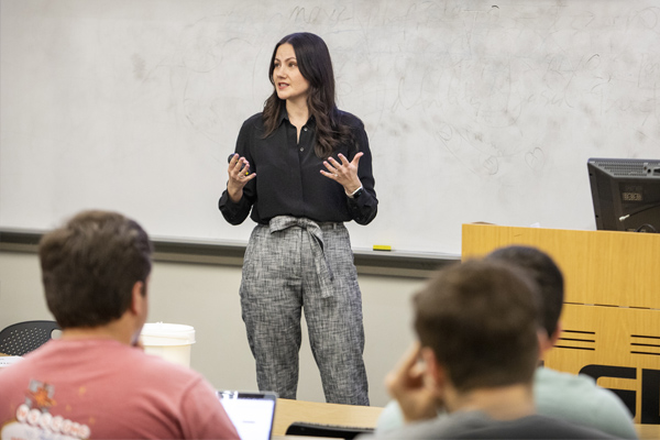 Professor teaches at front of classroom.