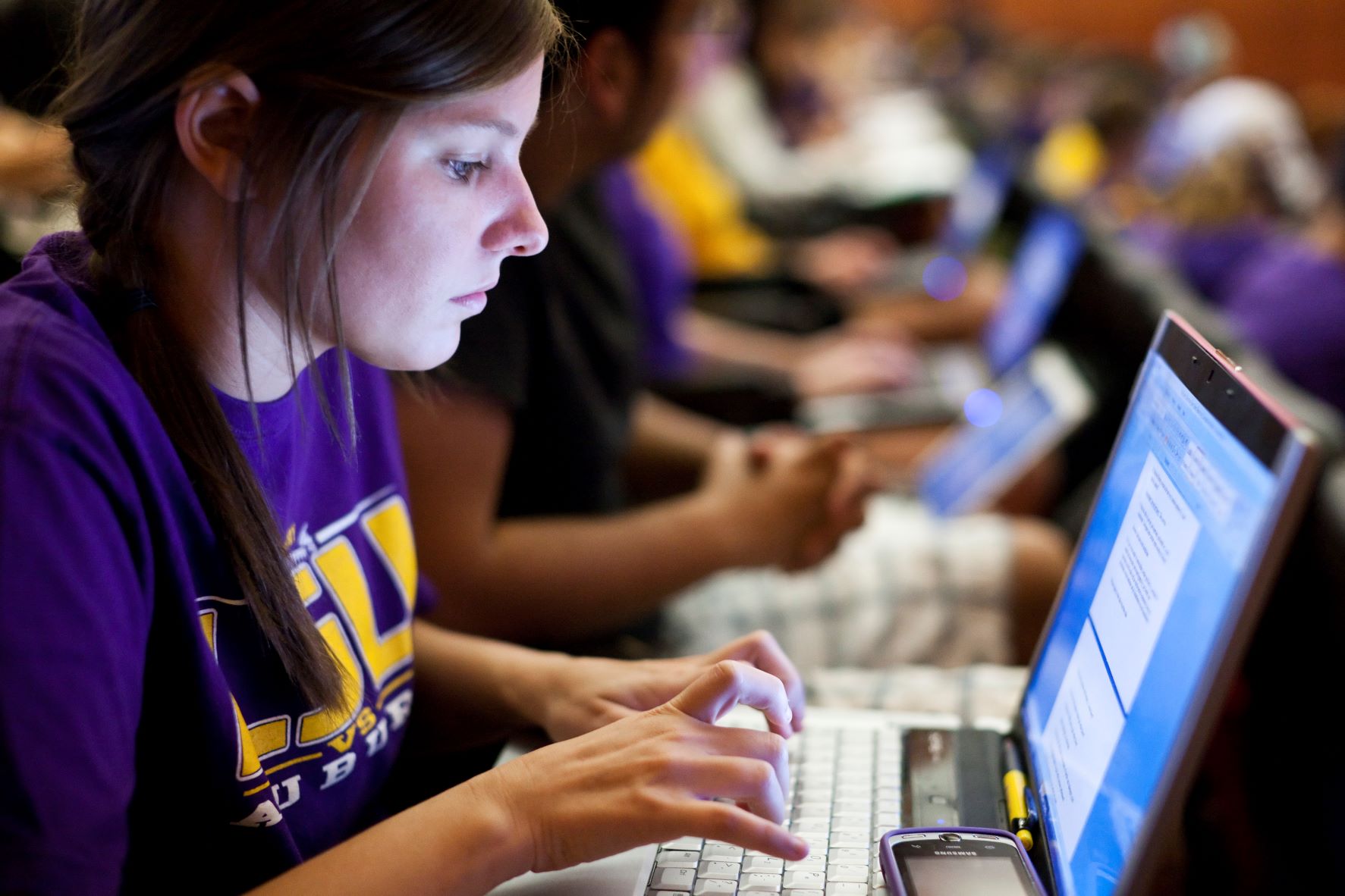 Student types on laptop.