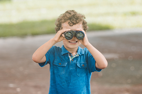 Child looking through binoculars