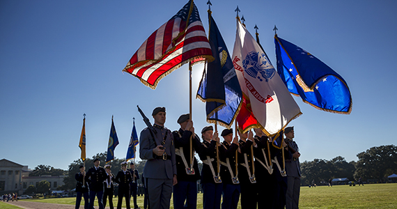 LSU Parade Grounds with military members holding flags during LSU Salutes.