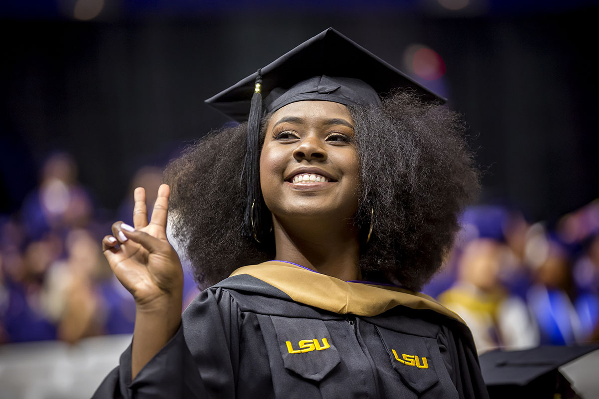 masters graduate peace sign