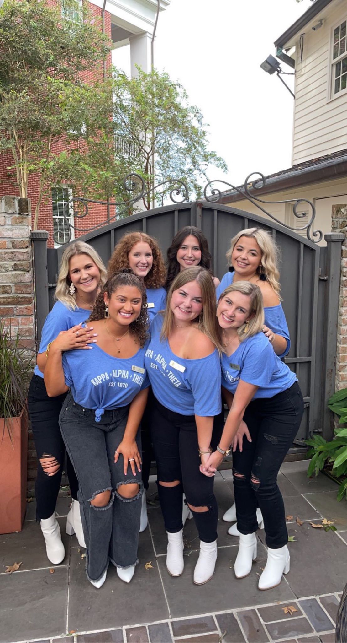 kappa alpha theta members pose in blue shirts