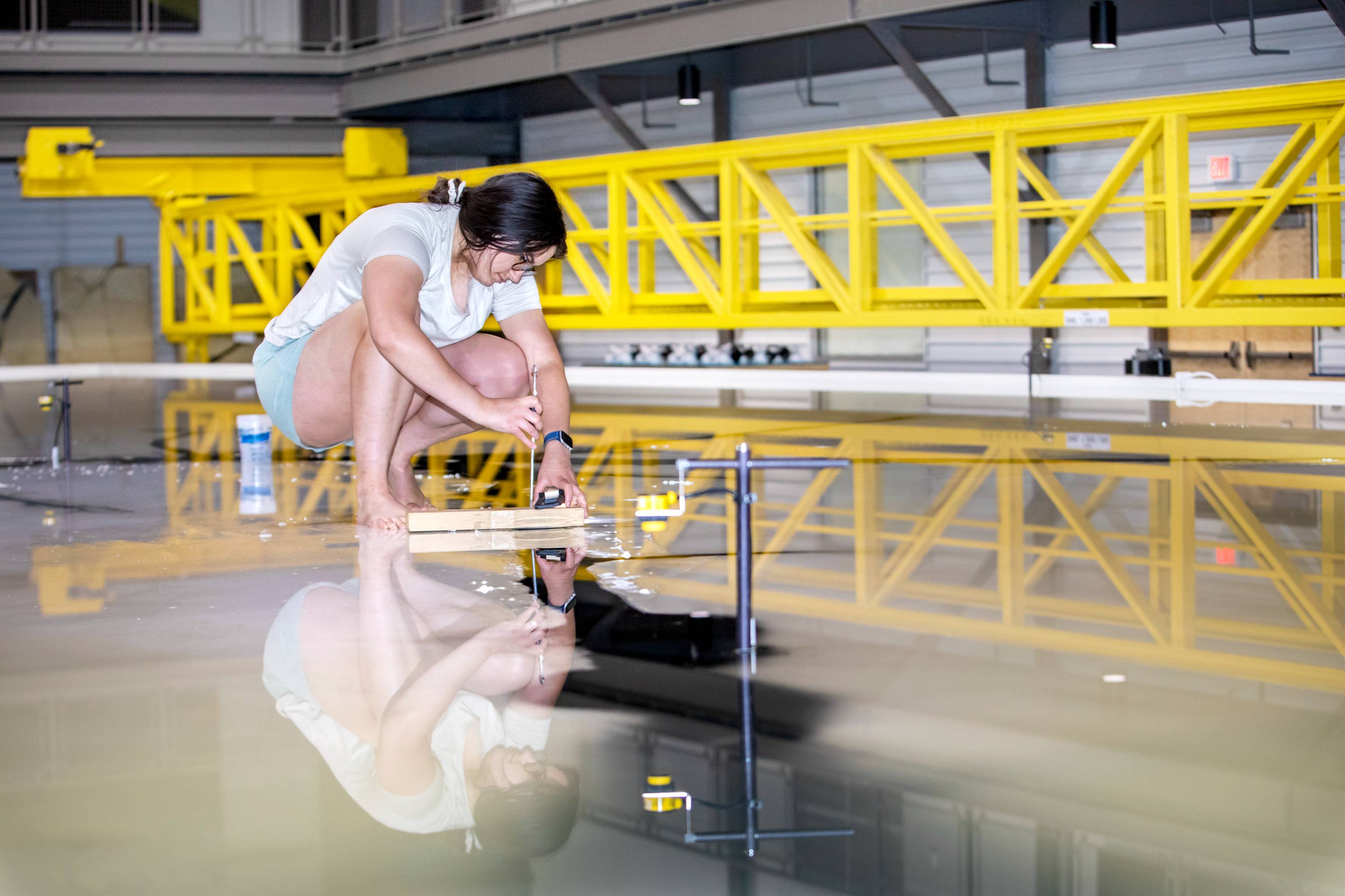 graduate student taking measurements at ms river model