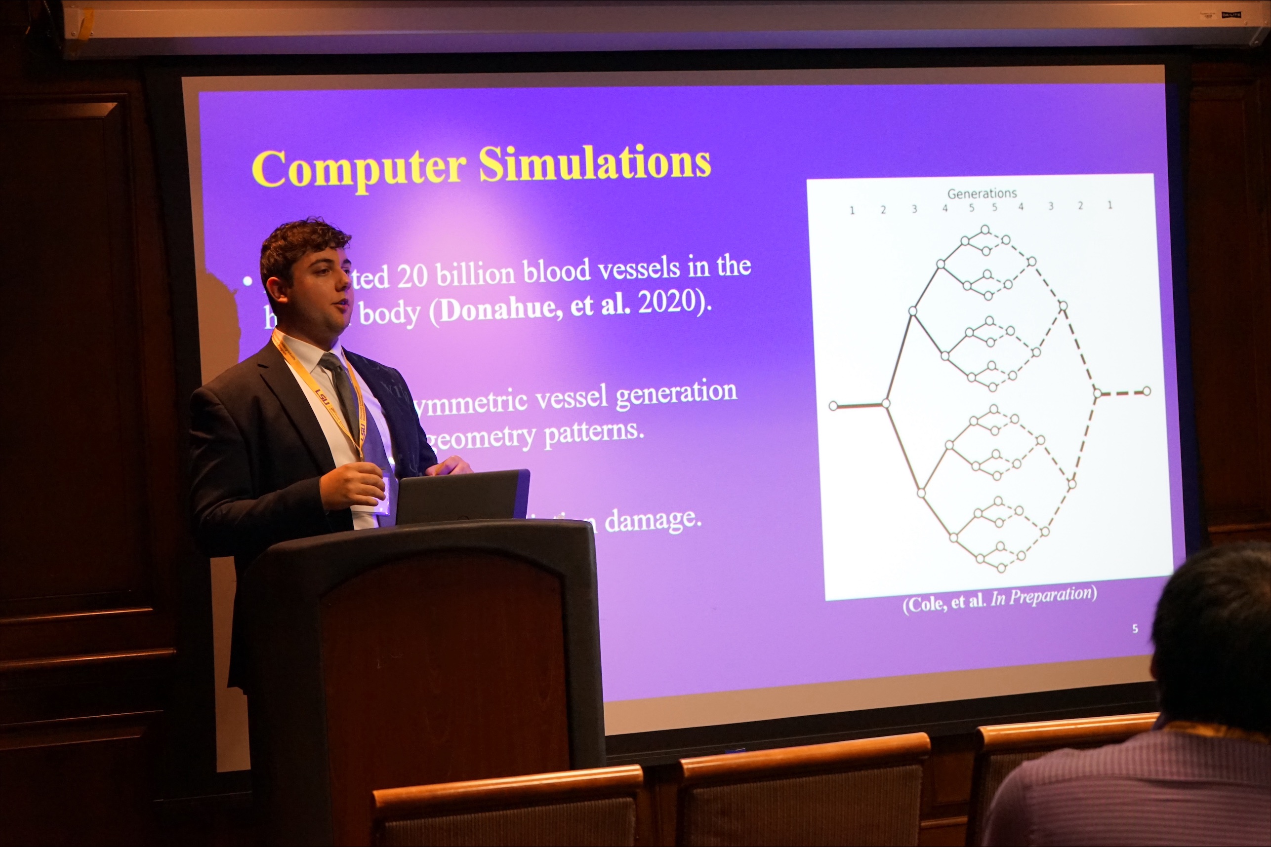 Christian in front of his slides at LSU Discover Day